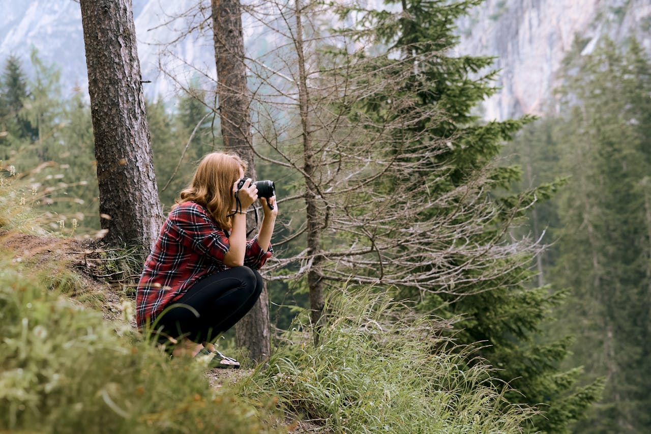 photographer-capturing-nature-in-a-forest-setting-32618021